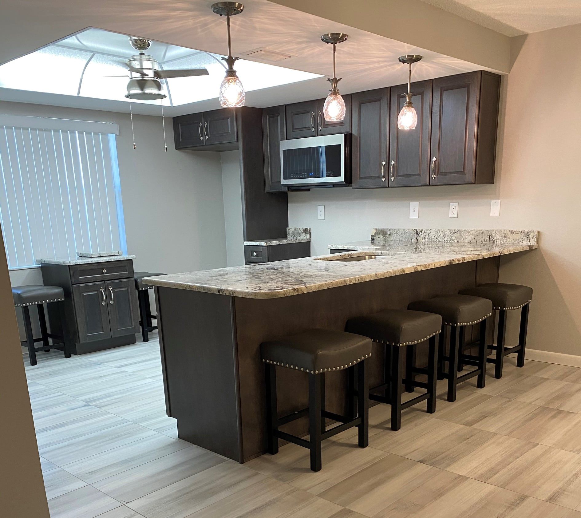 A kitchen with a large island and stools