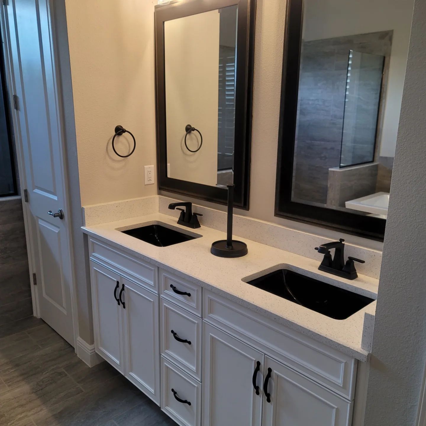 A bathroom with two sinks and two mirrors.