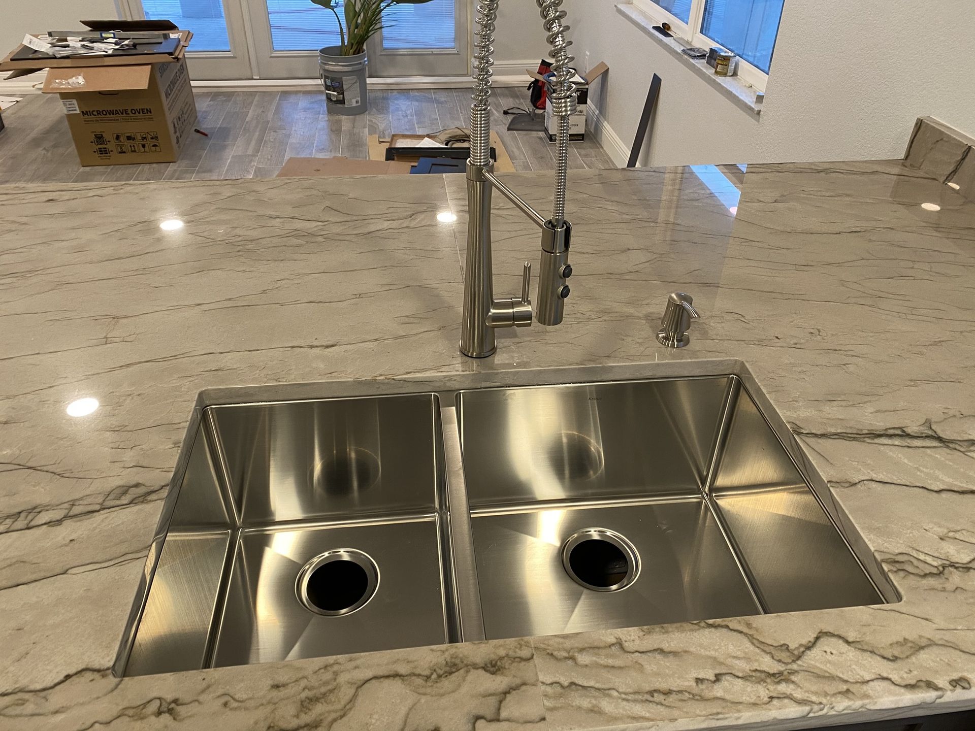 A stainless steel kitchen sink with two holes in it
