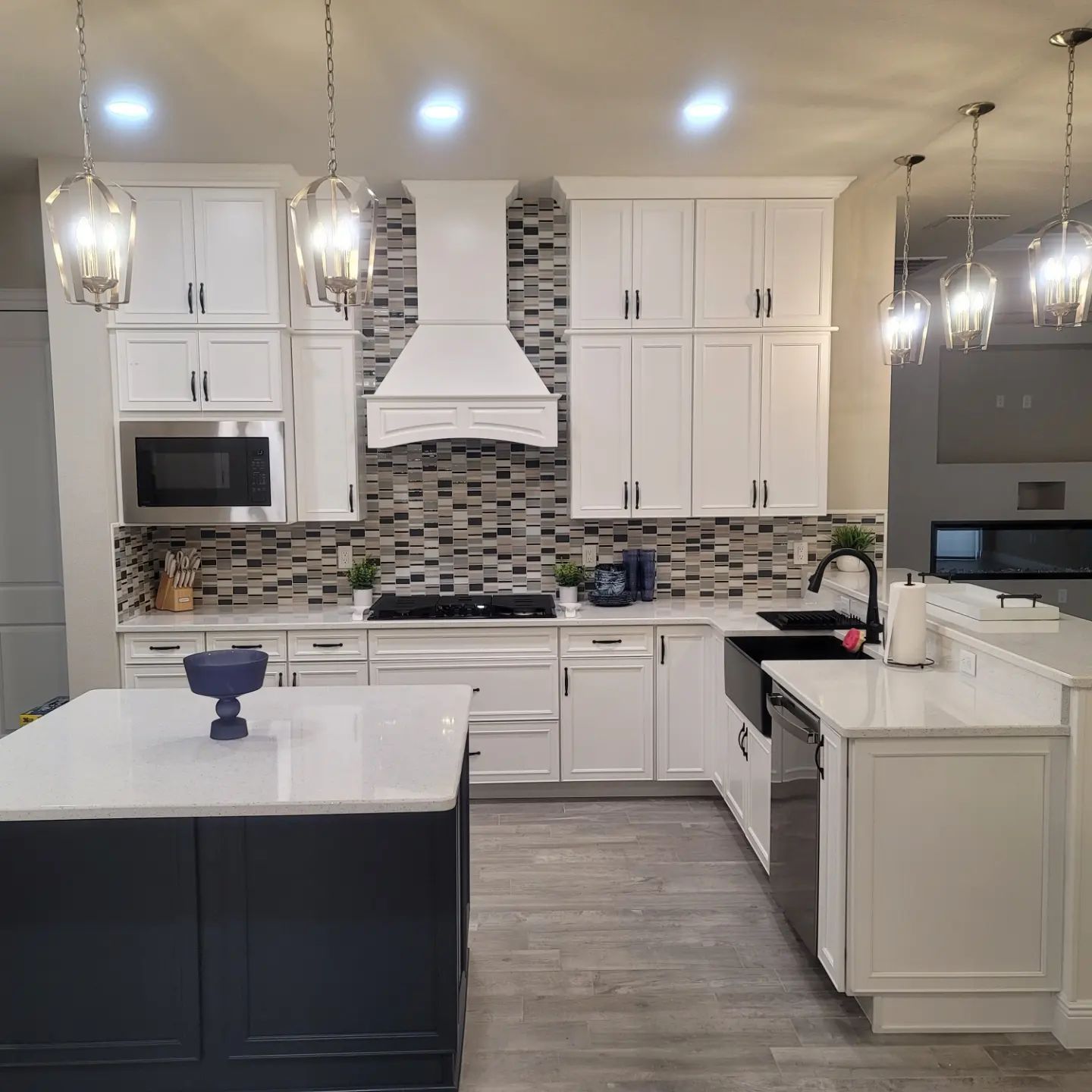 A kitchen with white cabinets and stainless steel appliances