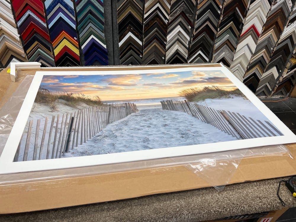 Artwork of beach pathway framed with assorted frame samples in background.