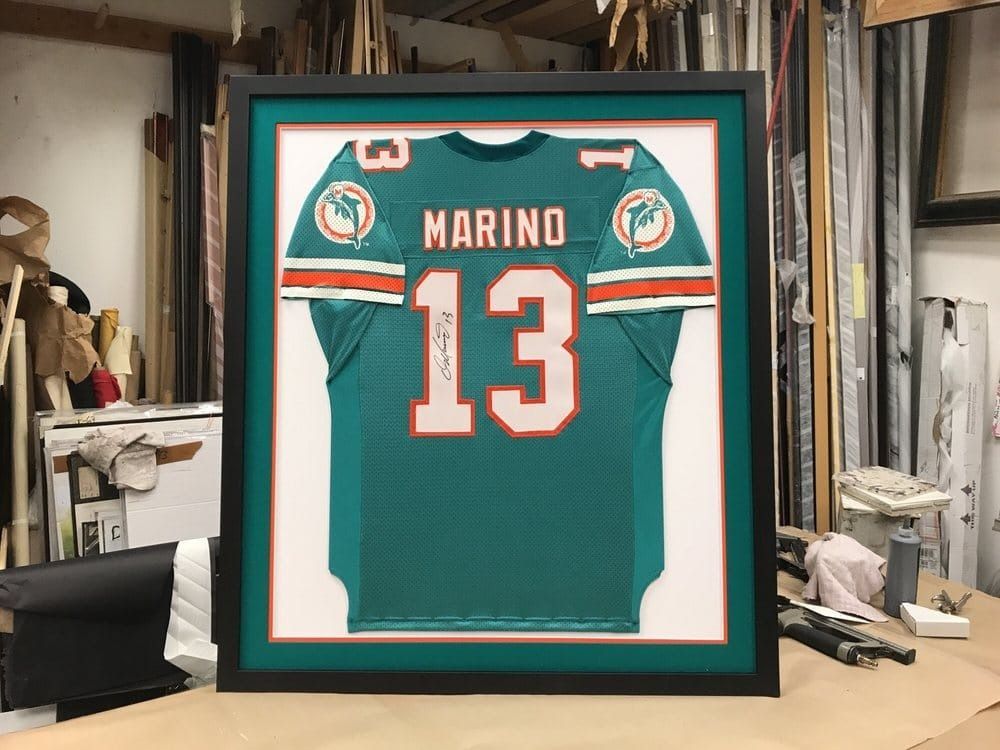 Framed teal Miami Dolphins football jersey with 