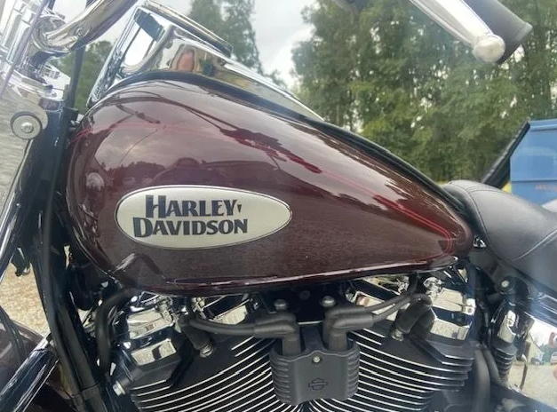 Maroon Harley-Davidson motorcycle fuel tank and chrome engine close-up