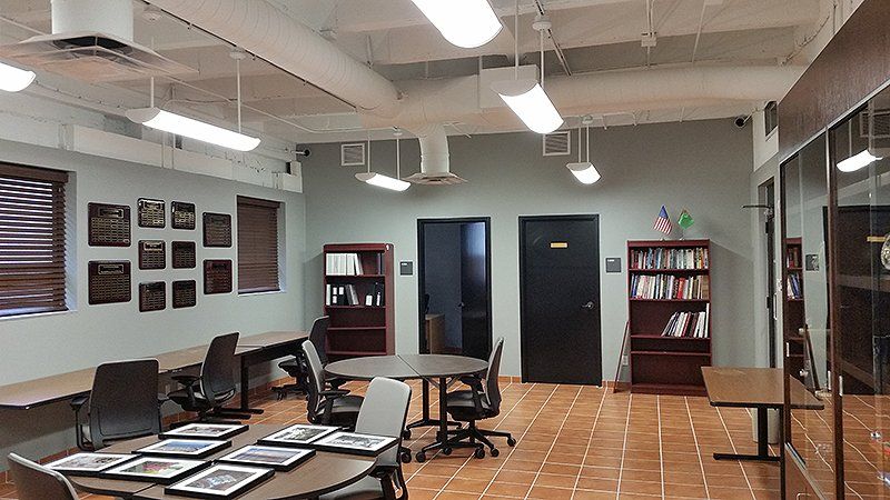 A large office room with tables and chairs in it