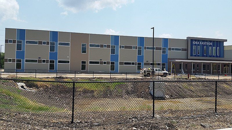A large building with a fence in front of it