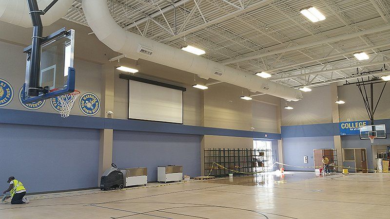 basketball hoops hanging from the ceiling of a gym