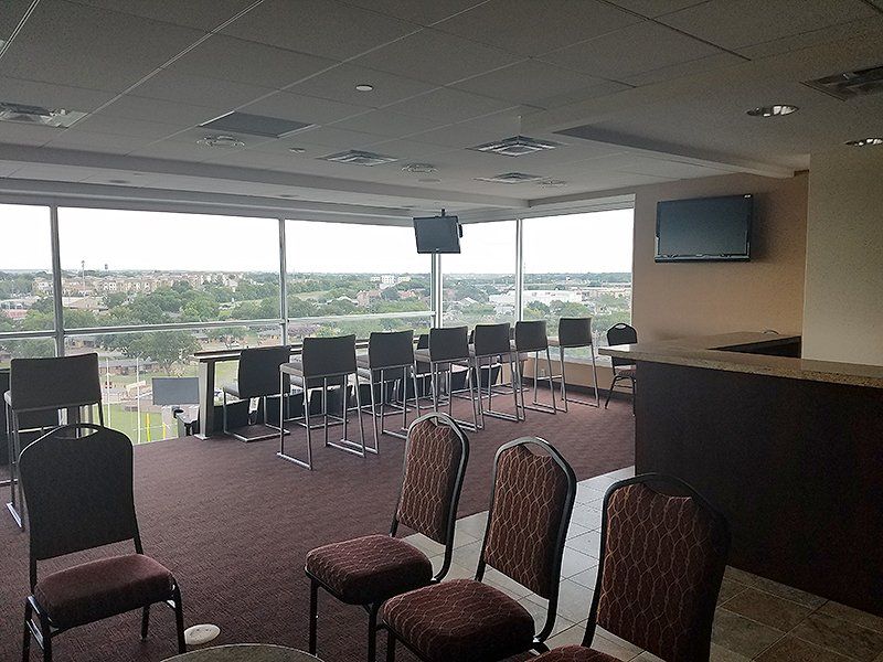 A large room with a lot of chairs and tables and a view