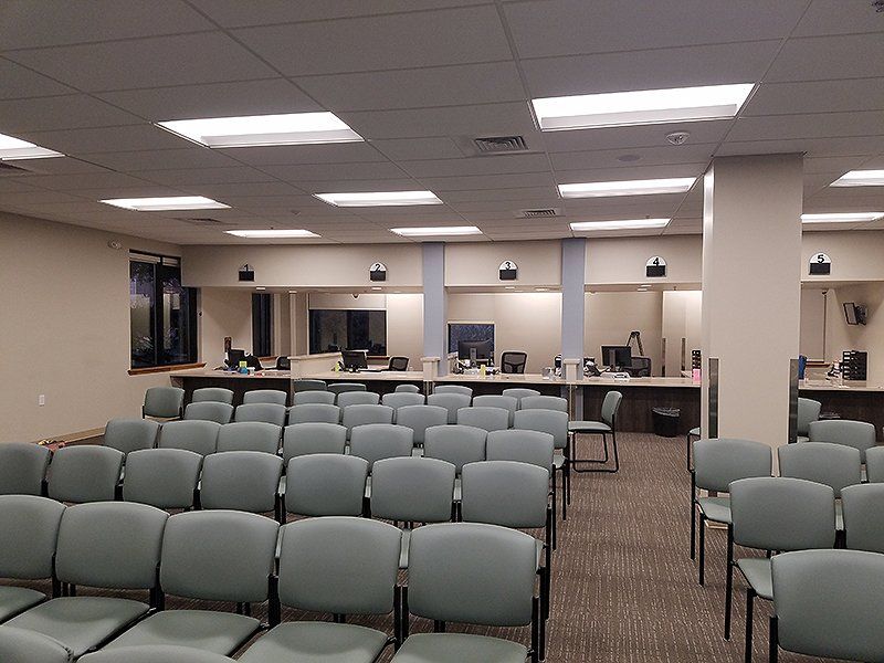 A large room with rows of chairs and office counters