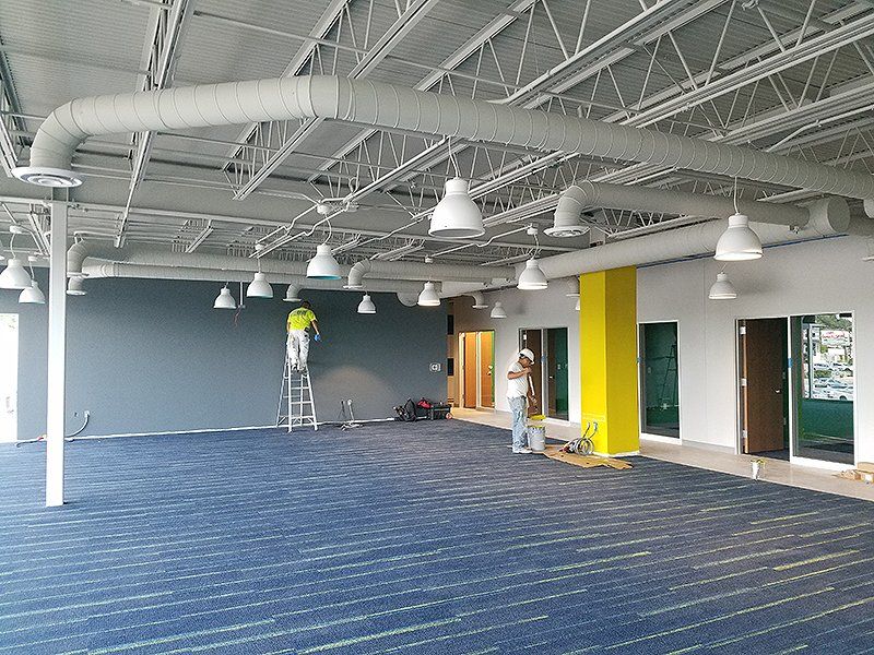 two men doing interior painting work