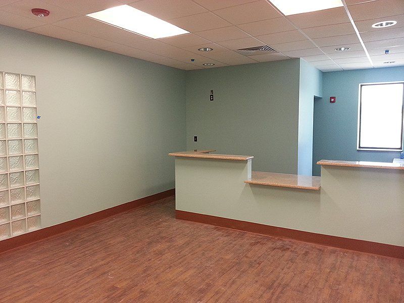 An empty room with a counter and a window