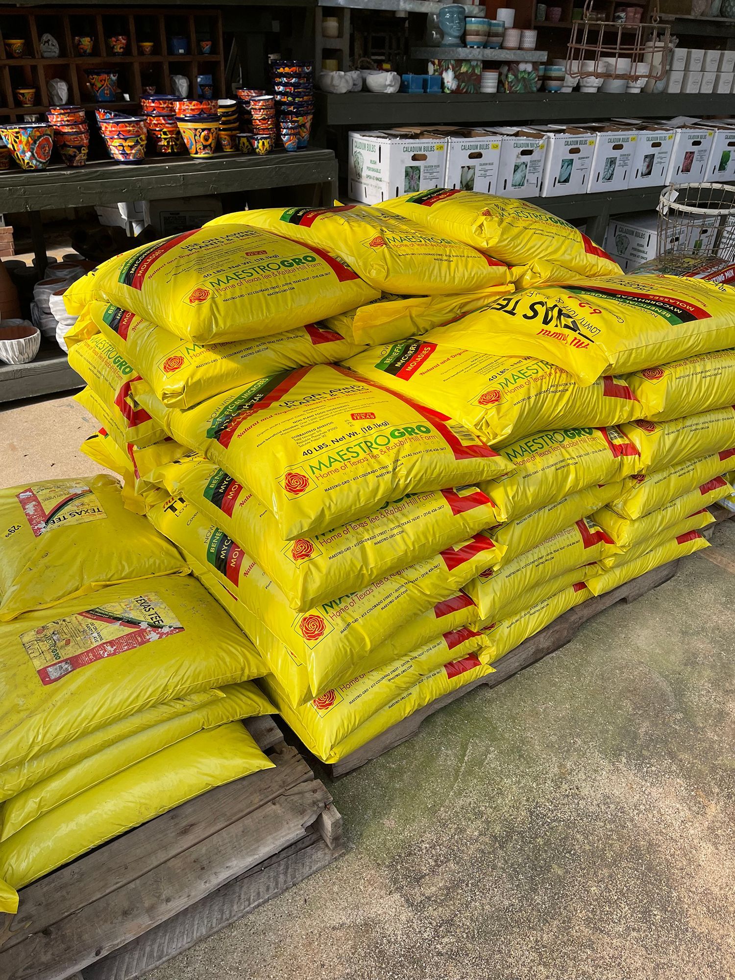 A pile of yellow bags sitting on top of a wooden pallet.