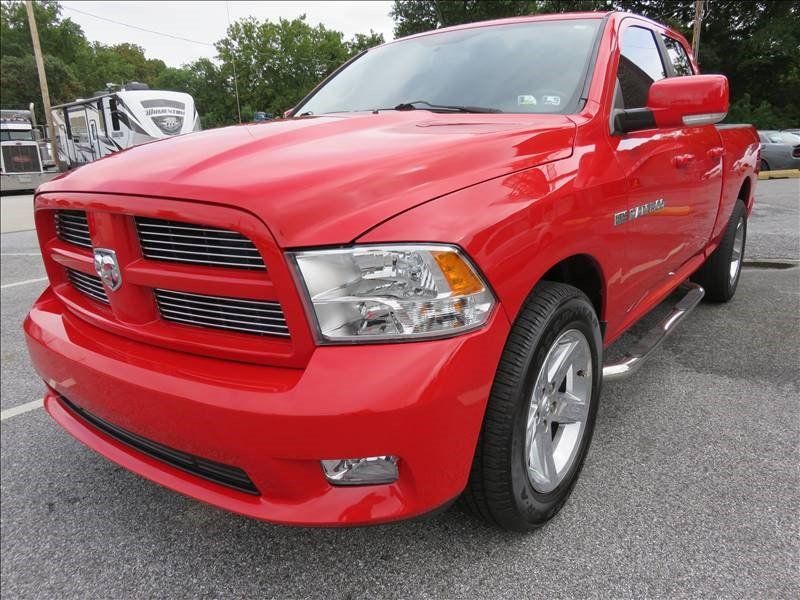 A red dodge ram truck is parked in a parking lot