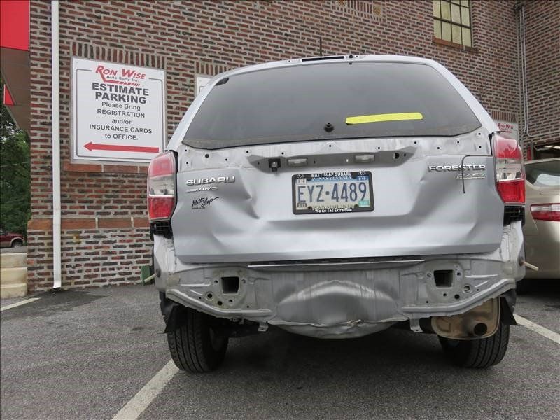 A silver car with a license plate that says eyz-4489