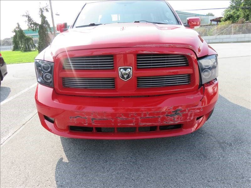 A red dodge ram truck is parked in a parking lot