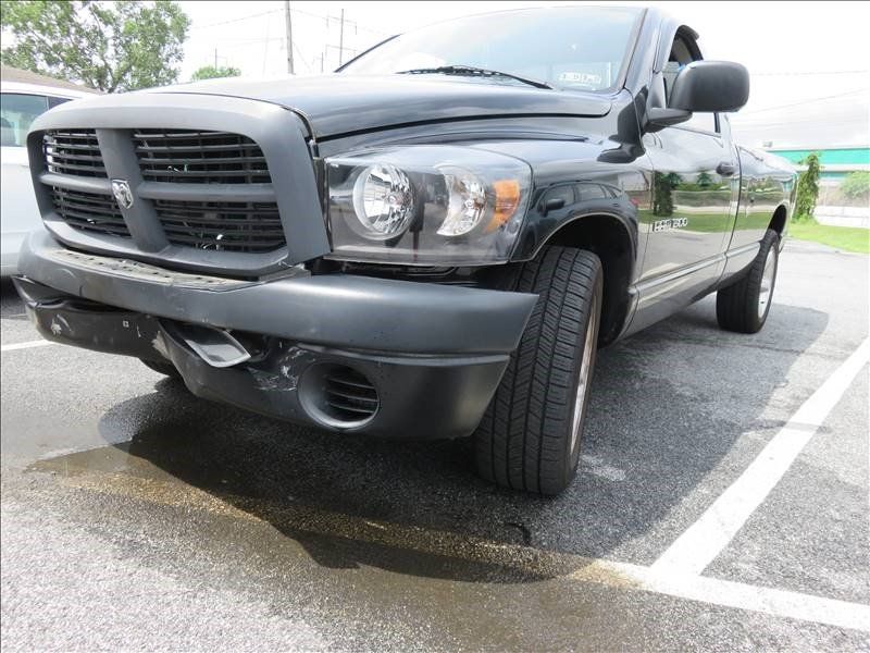 A black dodge ram truck is parked in a parking lot