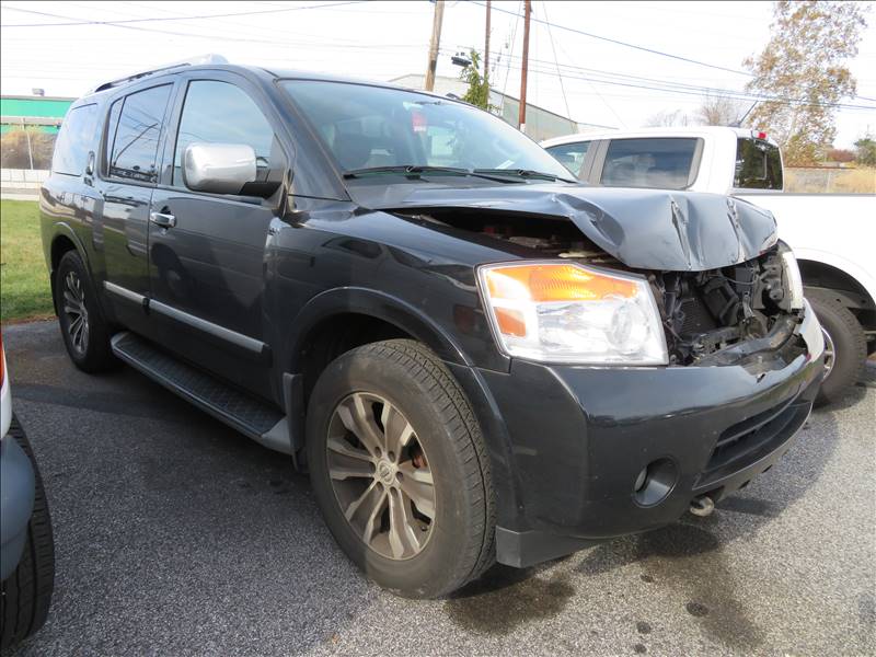 A black suv with a damaged hood is parked on the side of the road.