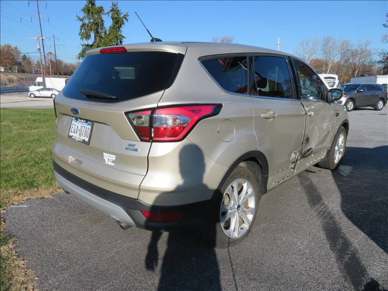 A ford escape is parked on the side of the road