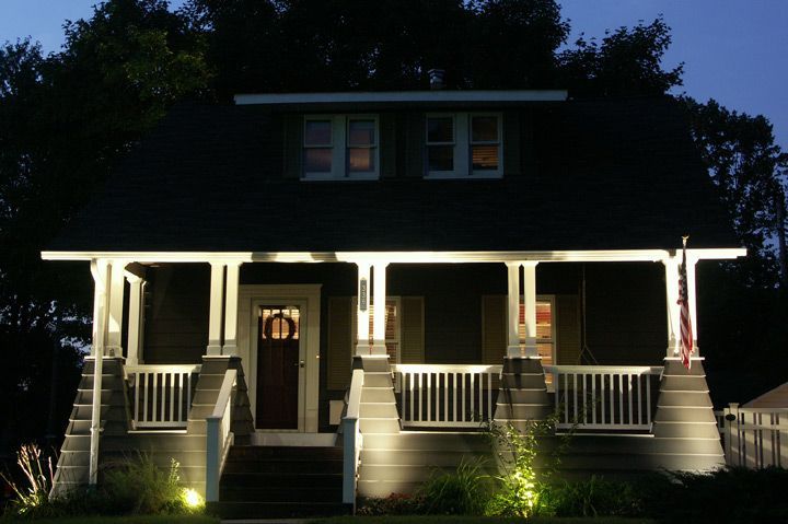 The front of a house is lit up at night