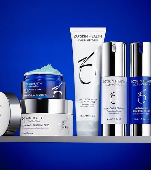 Zoskin Health skincare products in white, silver, and blue on a blue background