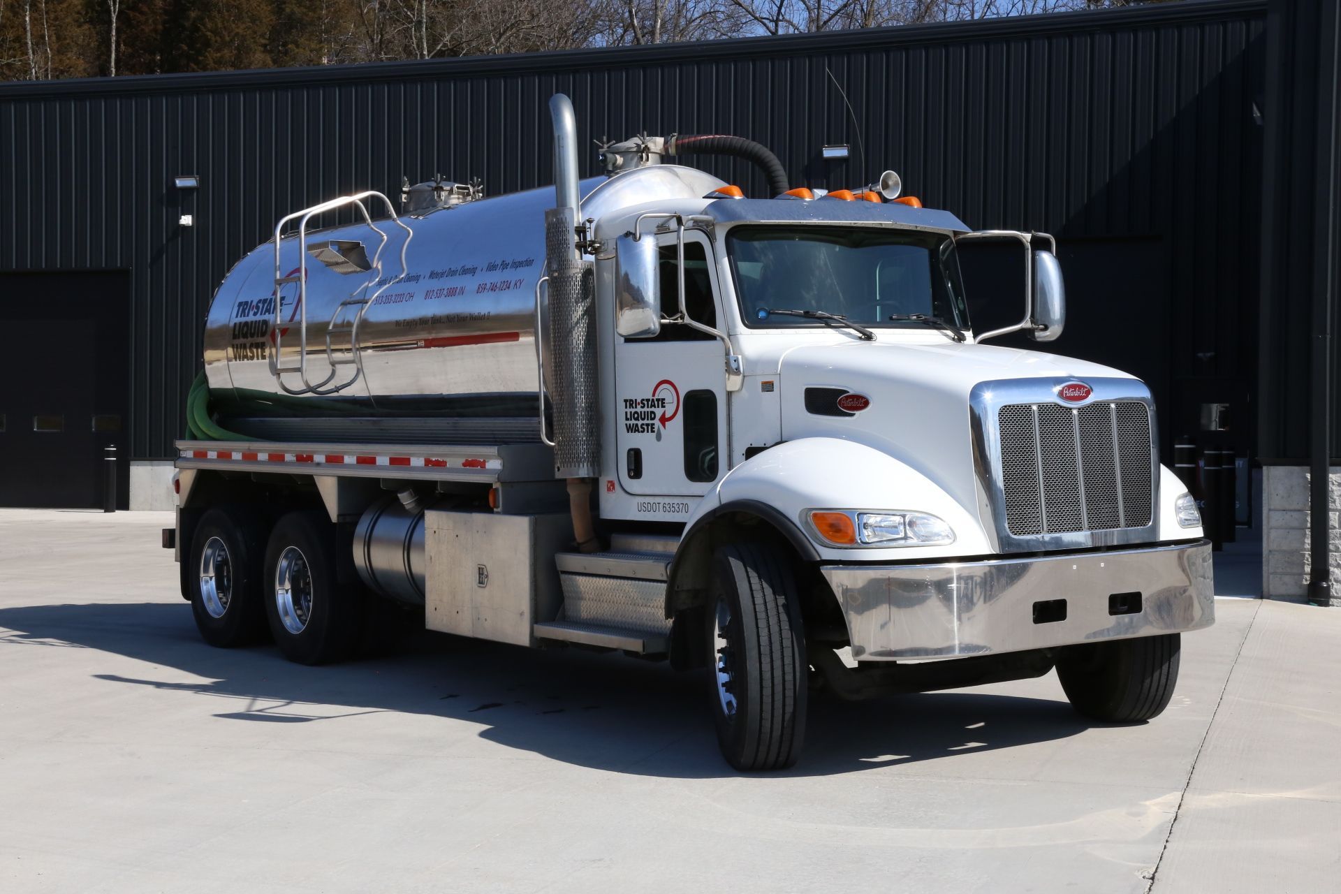a white semi truck is parked in front of a building .
