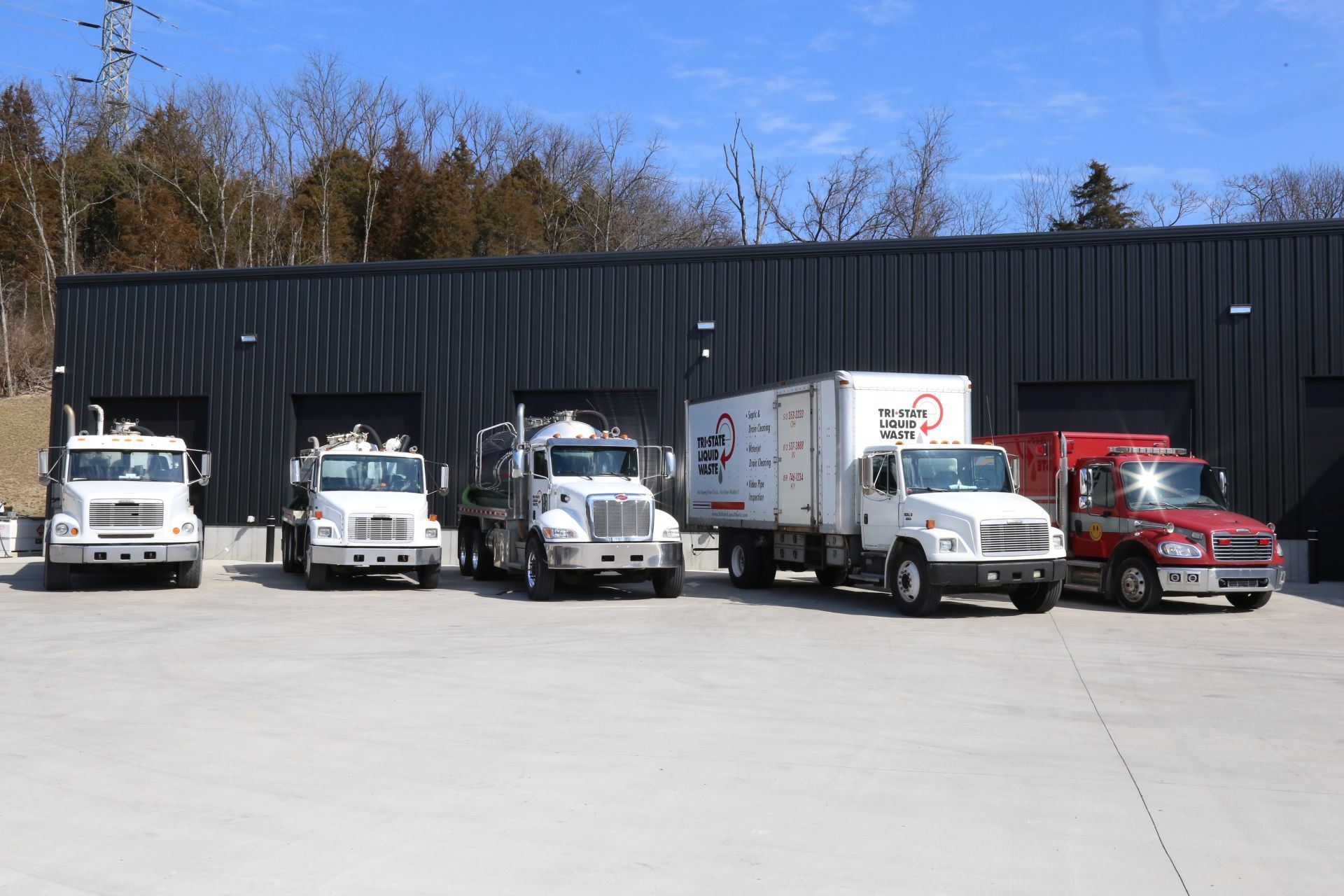 a row of trucks parked in front of a building .