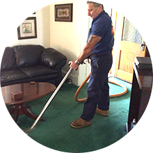 A man cleaning the carpet