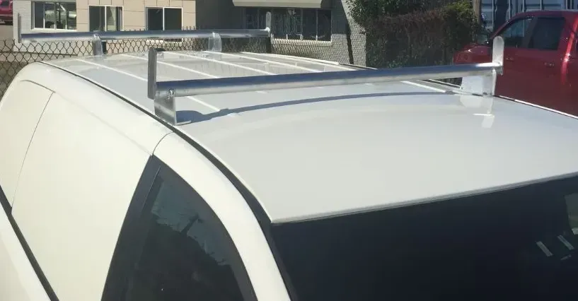 White van with a silver roof rack.