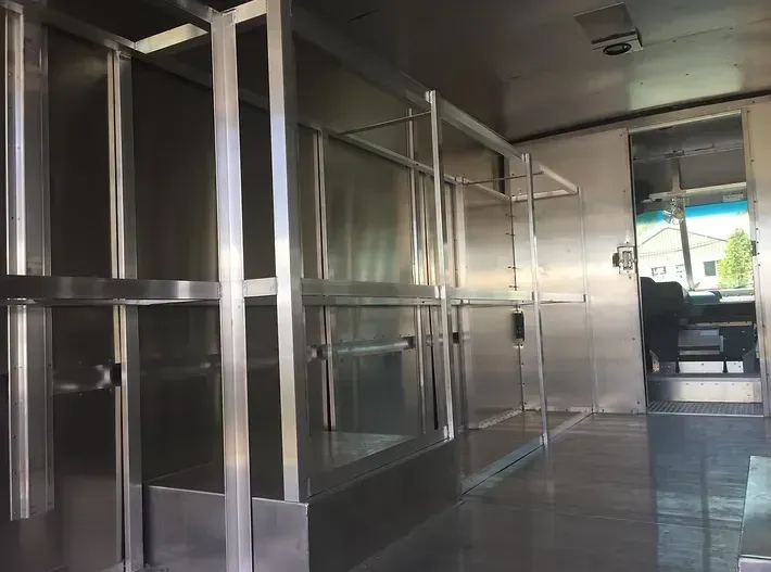 Interior of a food truck, stainless steel shelving and counters.