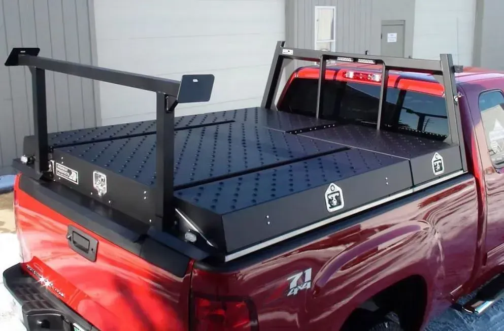 Red pickup truck with a black utility bed and overhead rack.