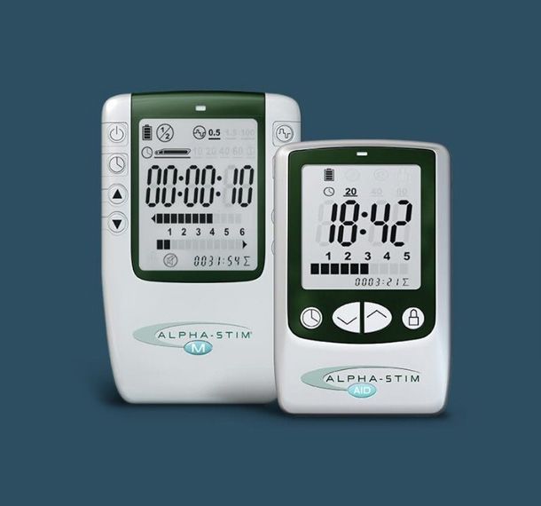 Two white and green Alpha-Stim devices with digital displays on a blue background