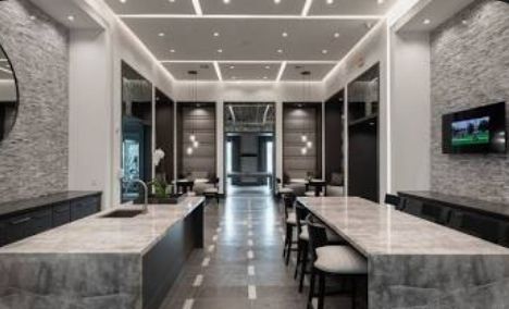 A large room with a long table and chairs in it.