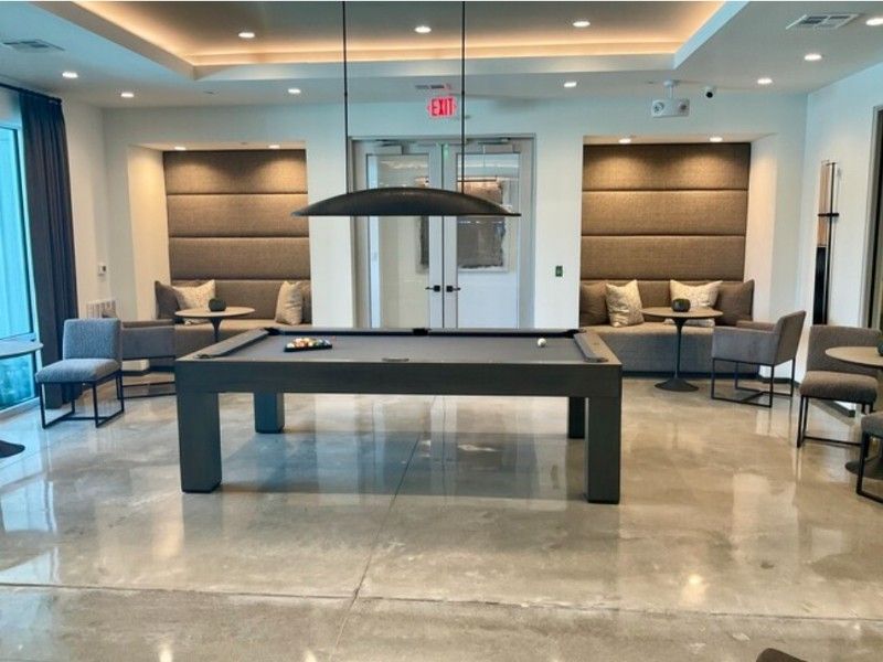 A pool table is in the middle of a living room