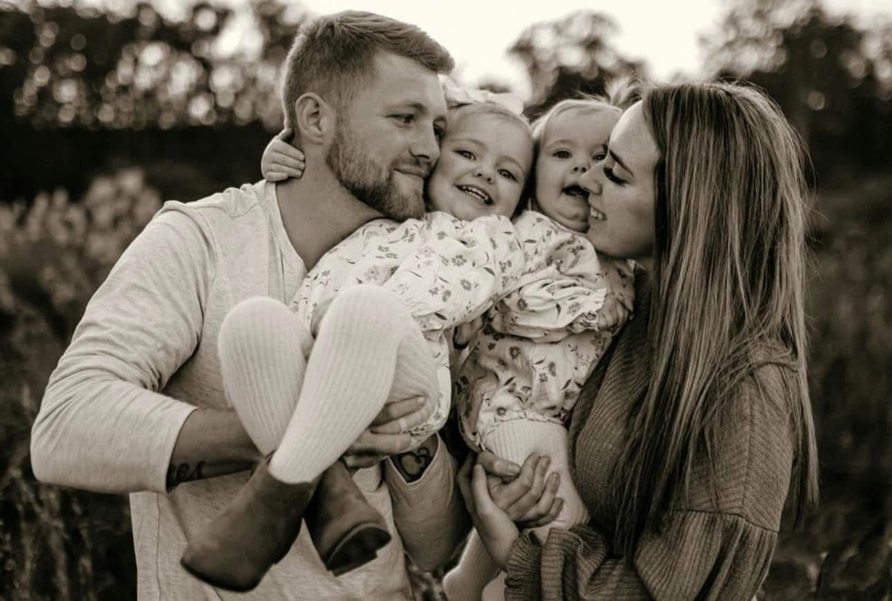 A black and white photo of a family posing for a picture.