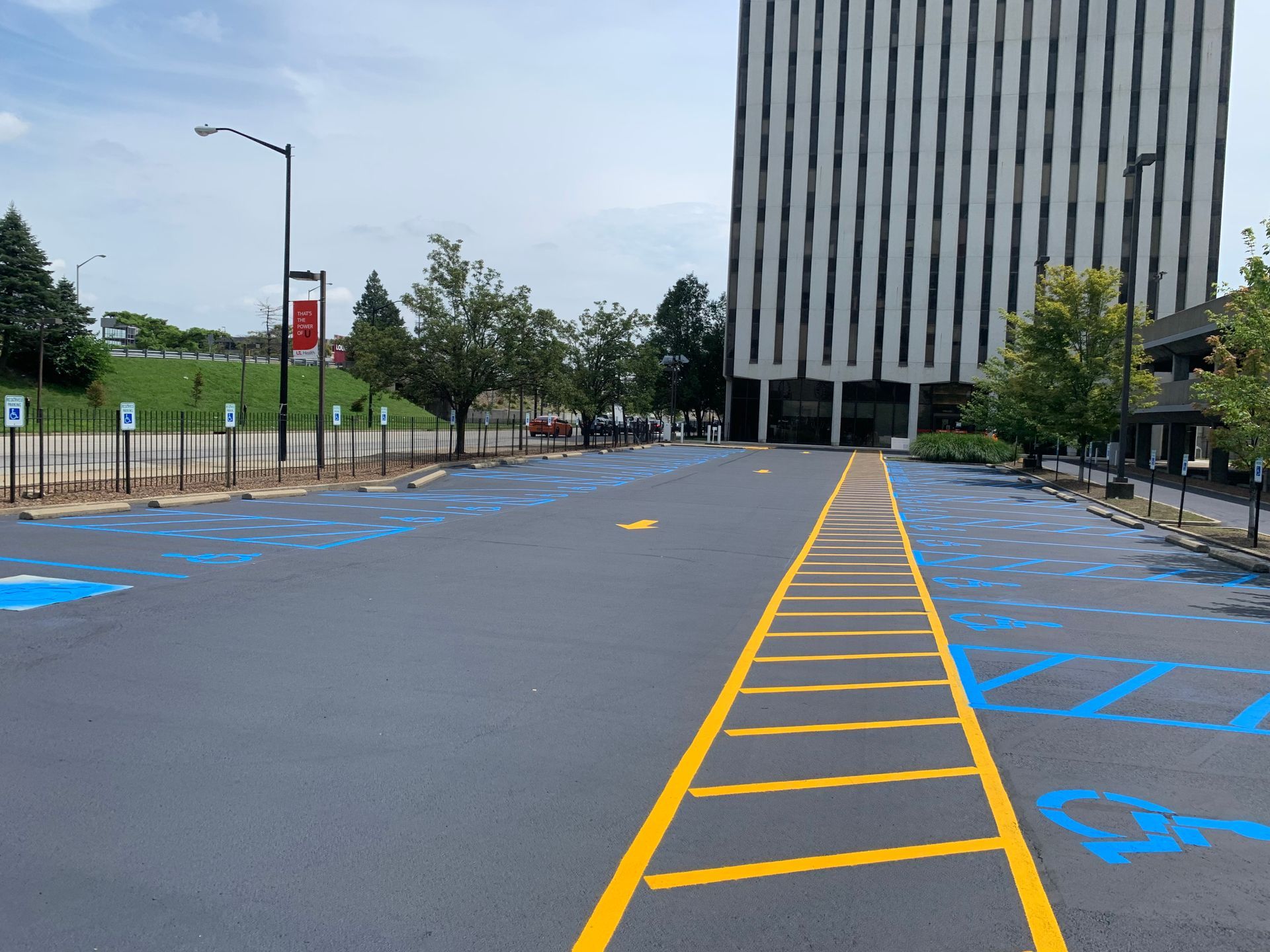 A parking lot with a handicapped parking spot and a building in the background.