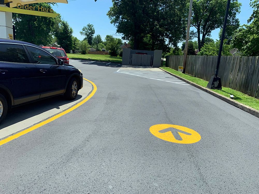 A yellow arrow is painted on the side of the road