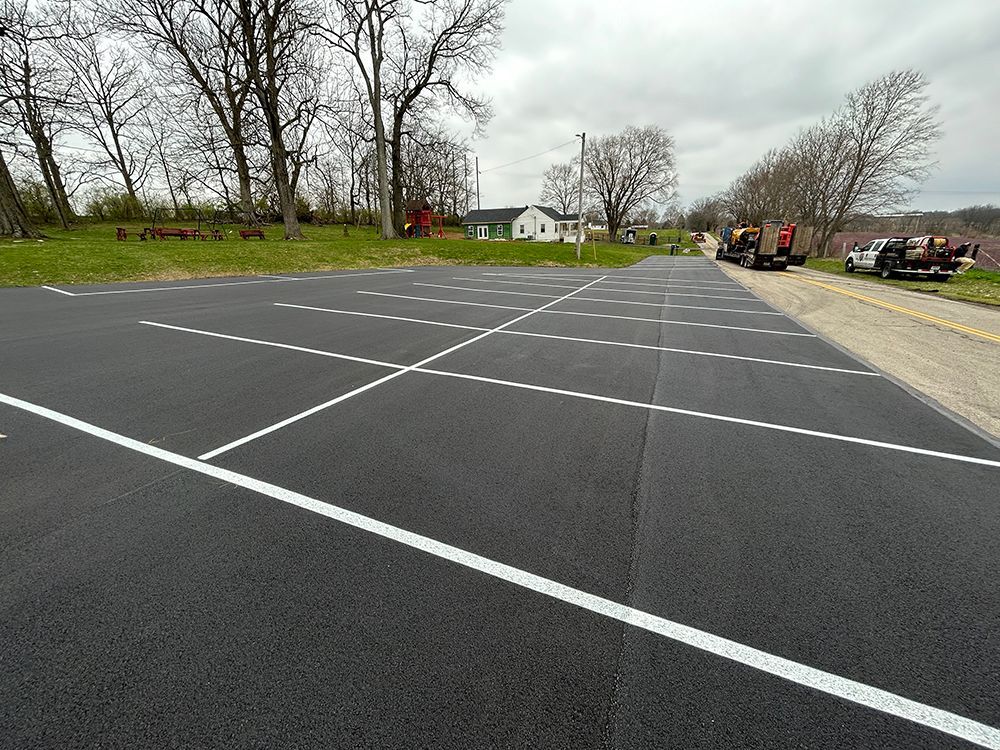 A parking lot with a white line on the side of the road.