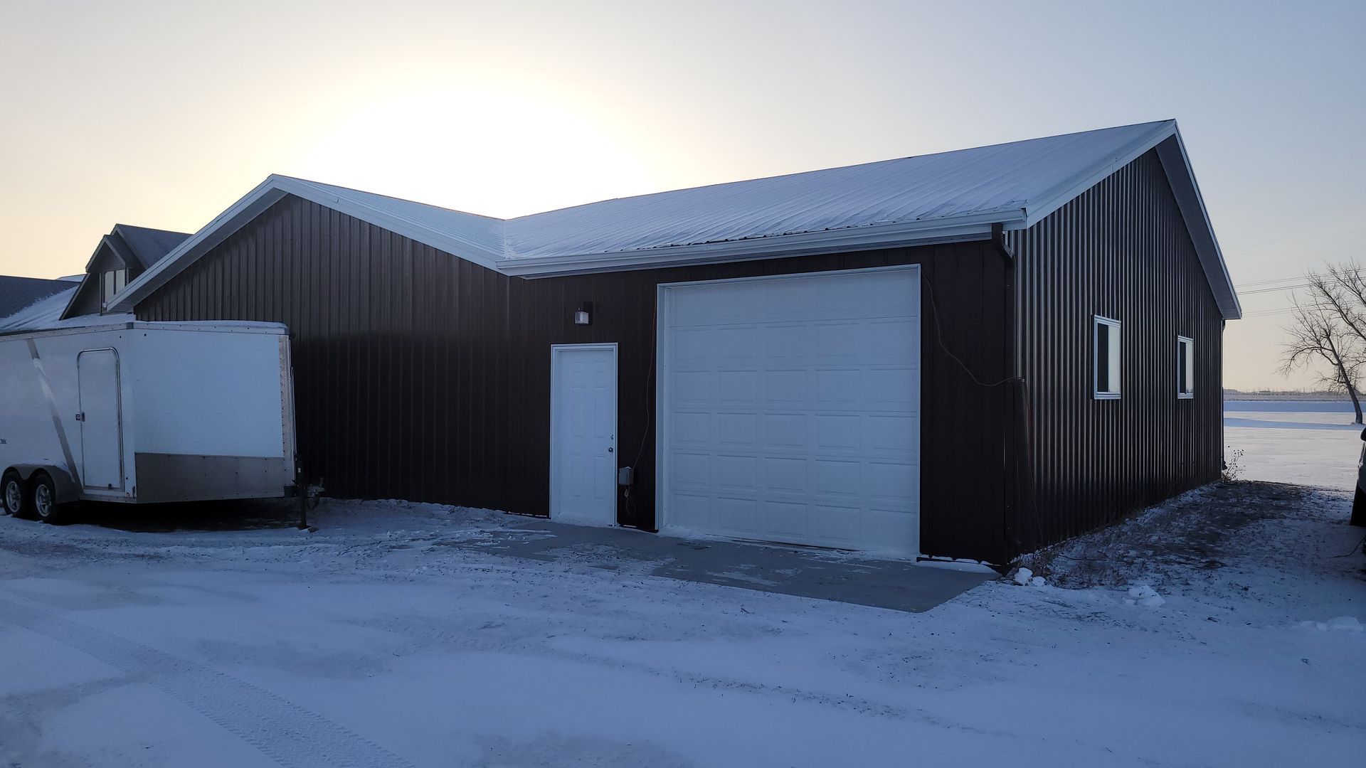 A brown building with a white garage door