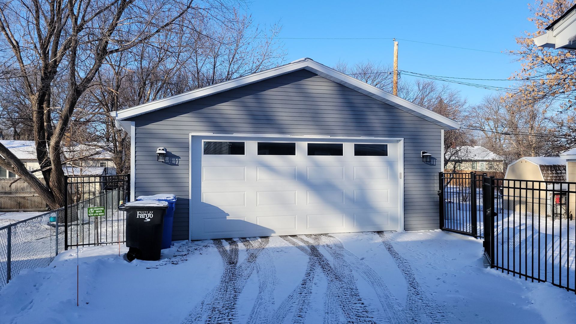 A white garage door covered in snow