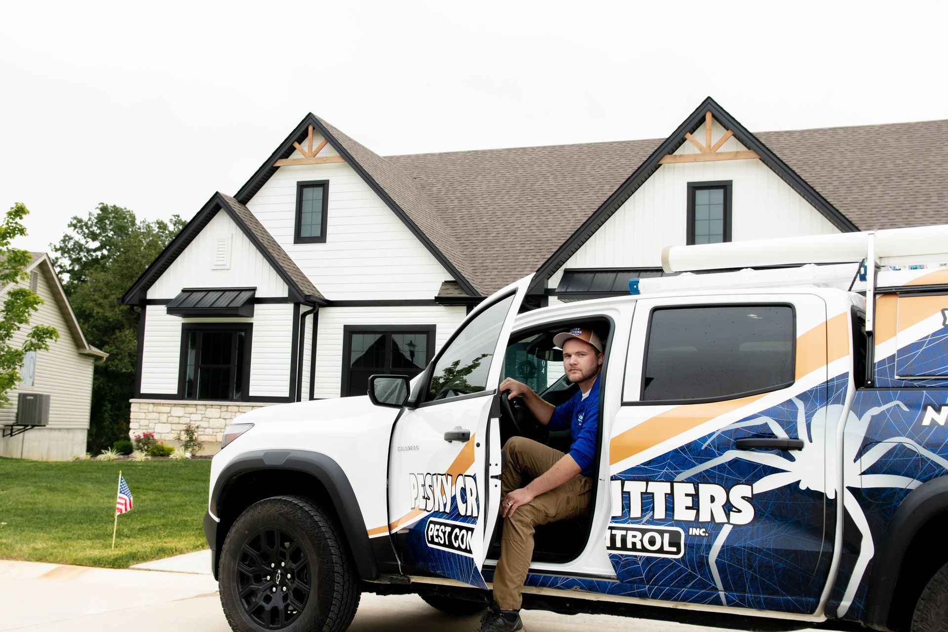 A service technician in a blue shirt exiting a branded white