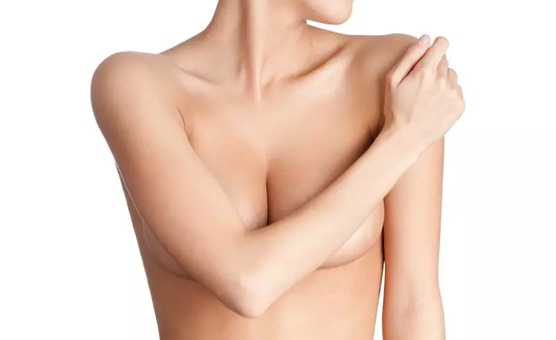 Bare torso with hand on shoulder.