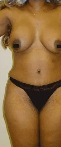 Person wearing black underwear, arm extended, standing in front of a white door.