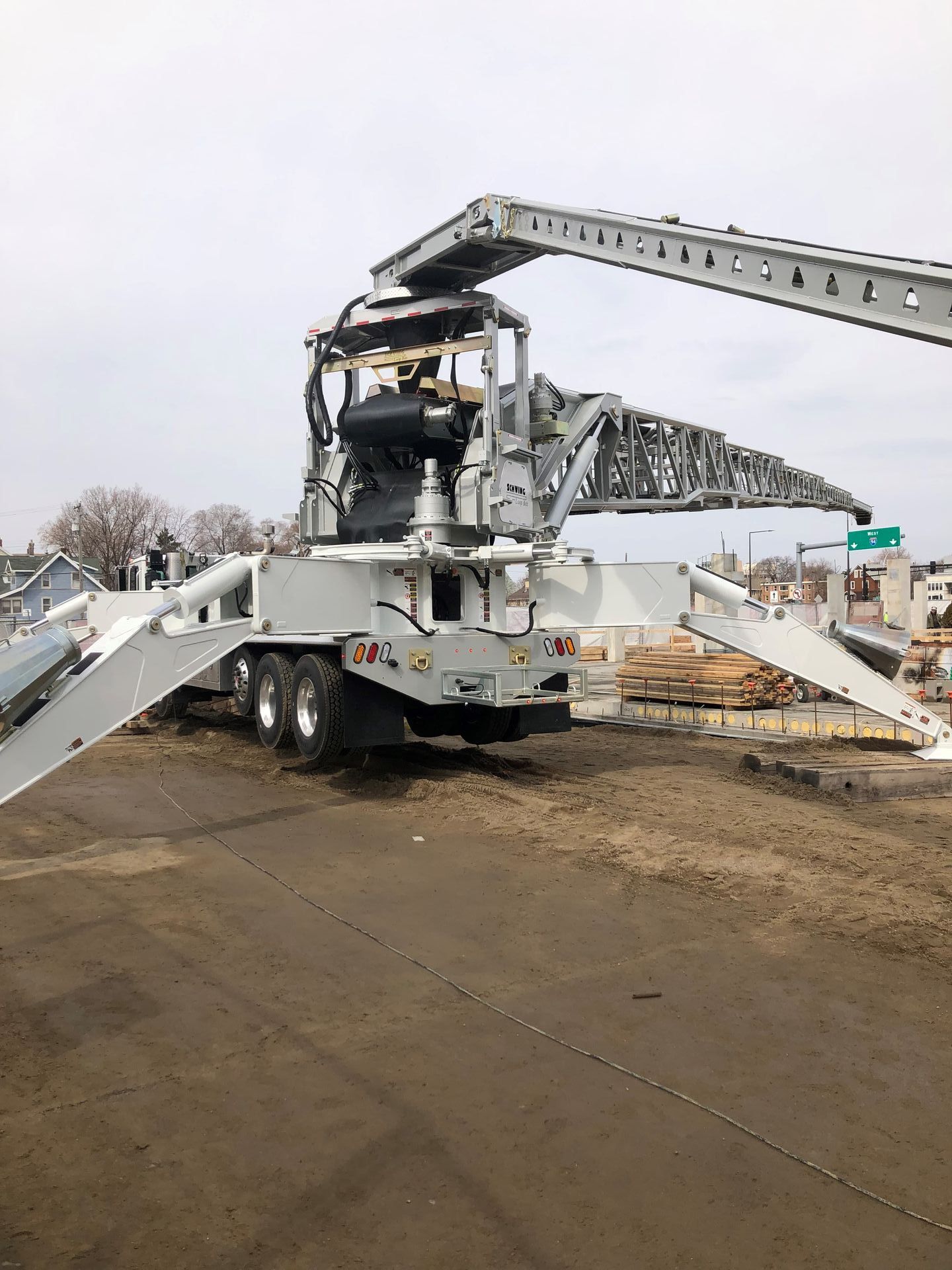 A large machine is parked on the side of the road.
