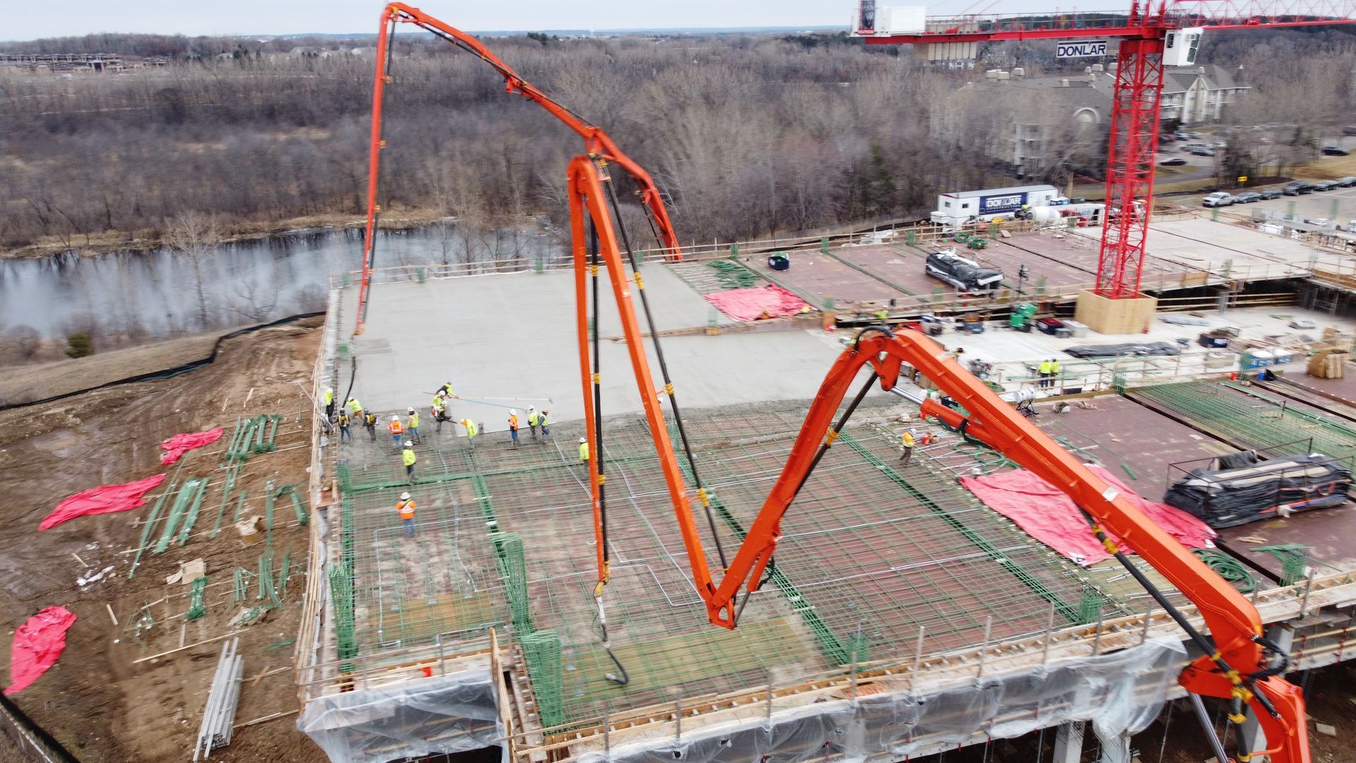 An aerial view of a construction site with a concrete pump.