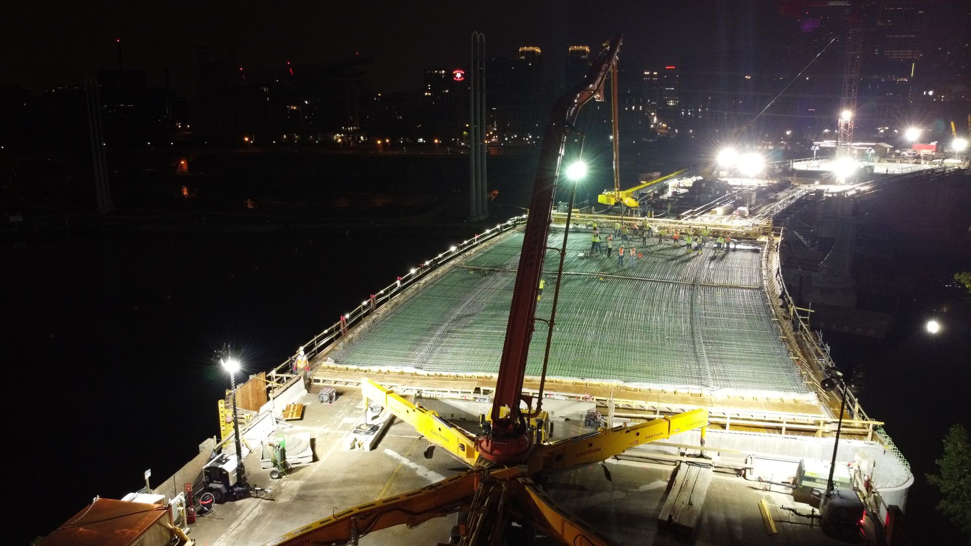 An aerial view of a bridge under construction at night.