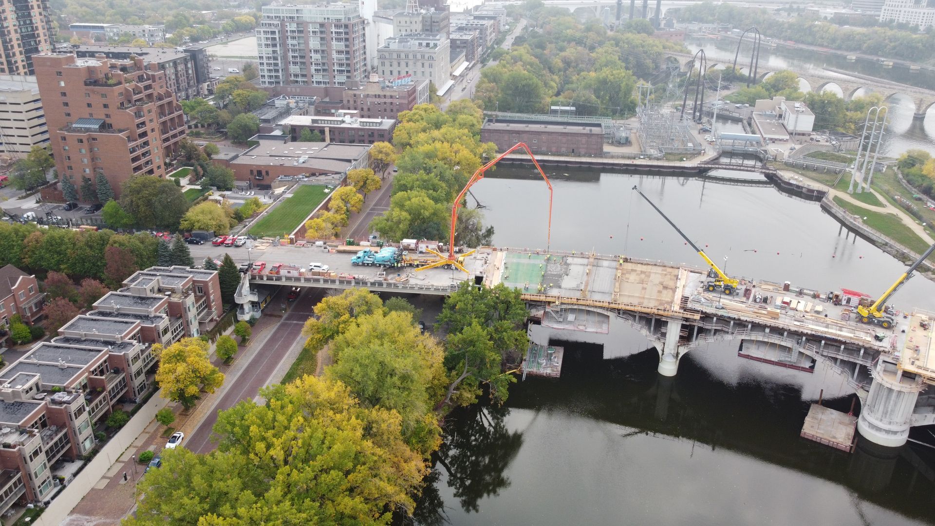 An aerial view of a bridge over a river in a city.