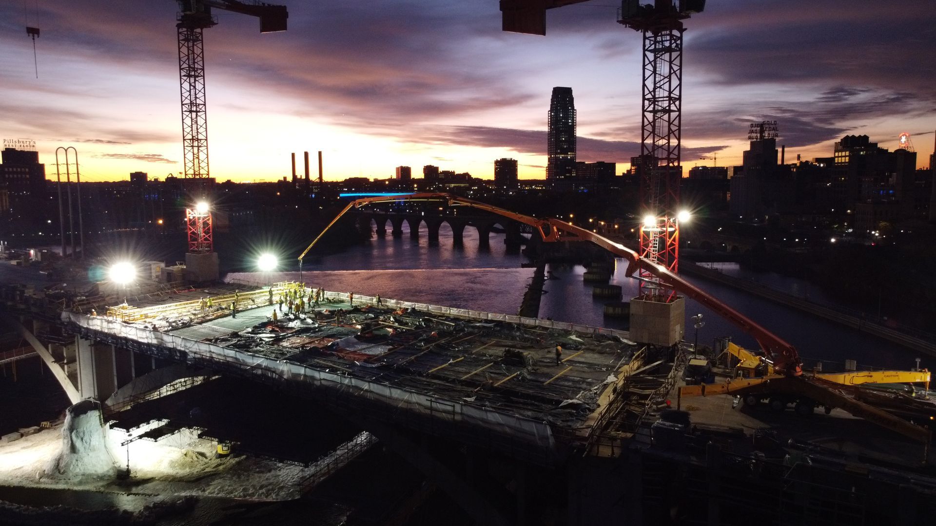 An aerial view of a bridge under construction at night.