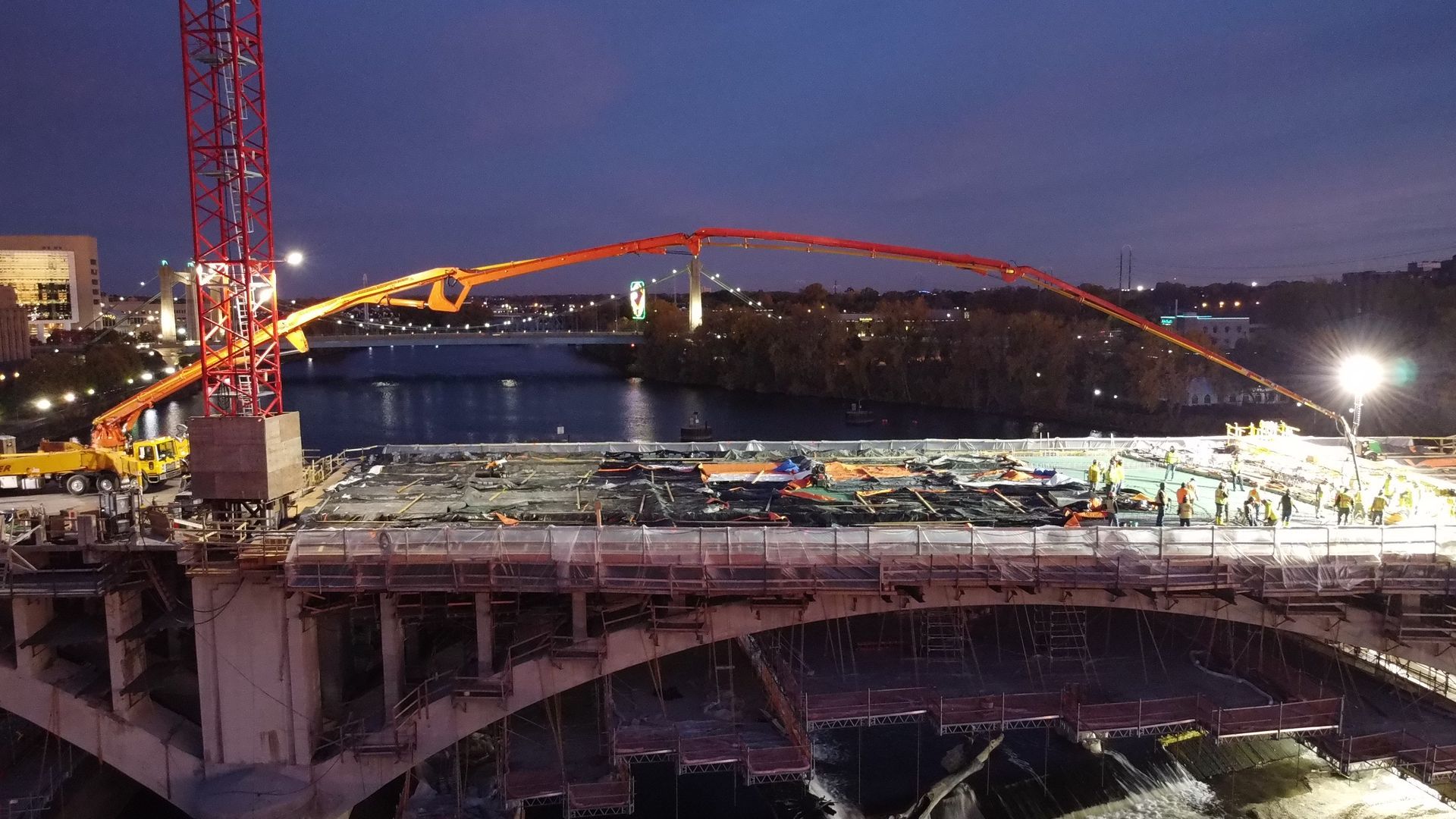 An aerial view of a bridge under construction at night.