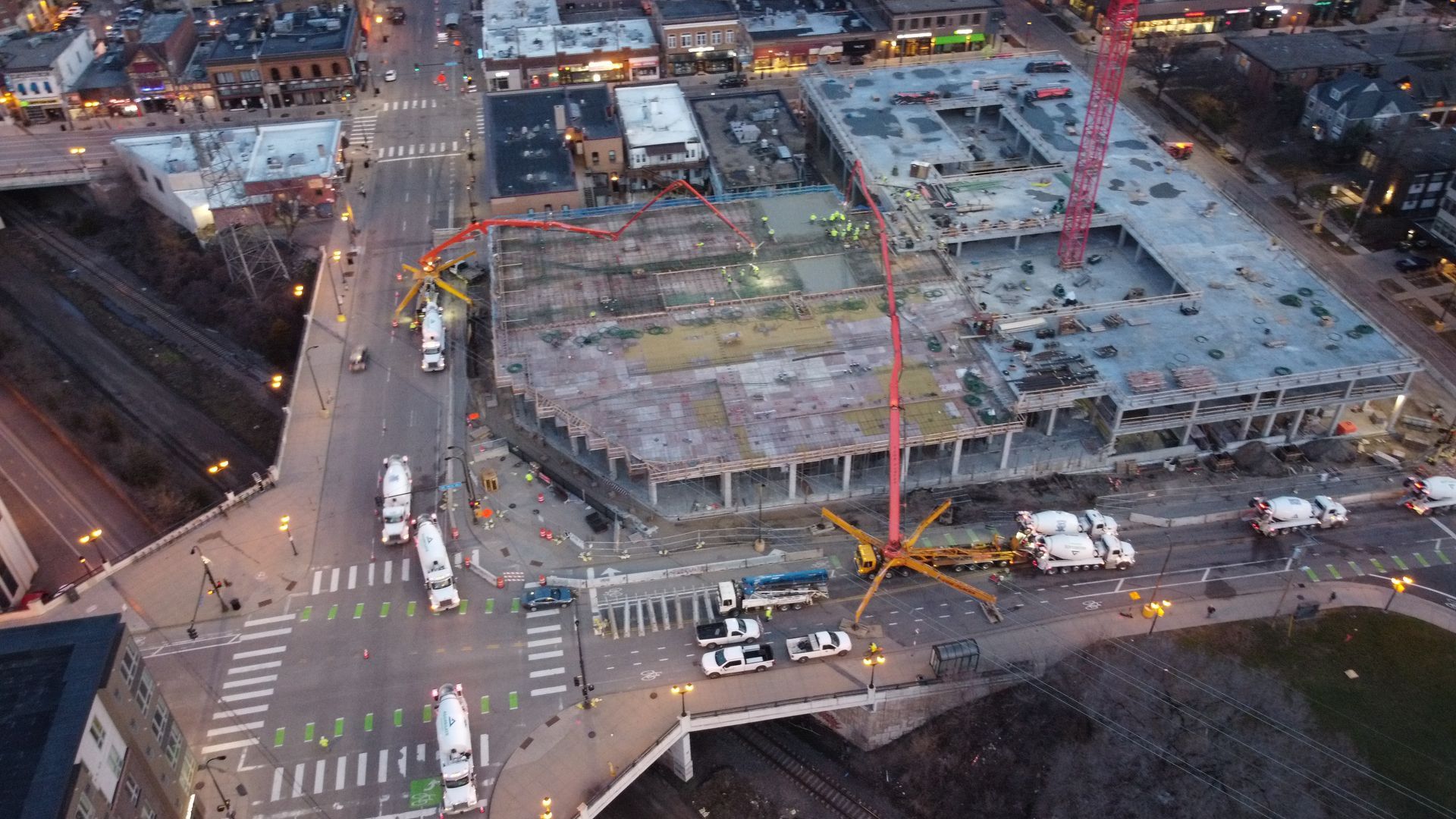 An aerial view of a large building under construction in a city.