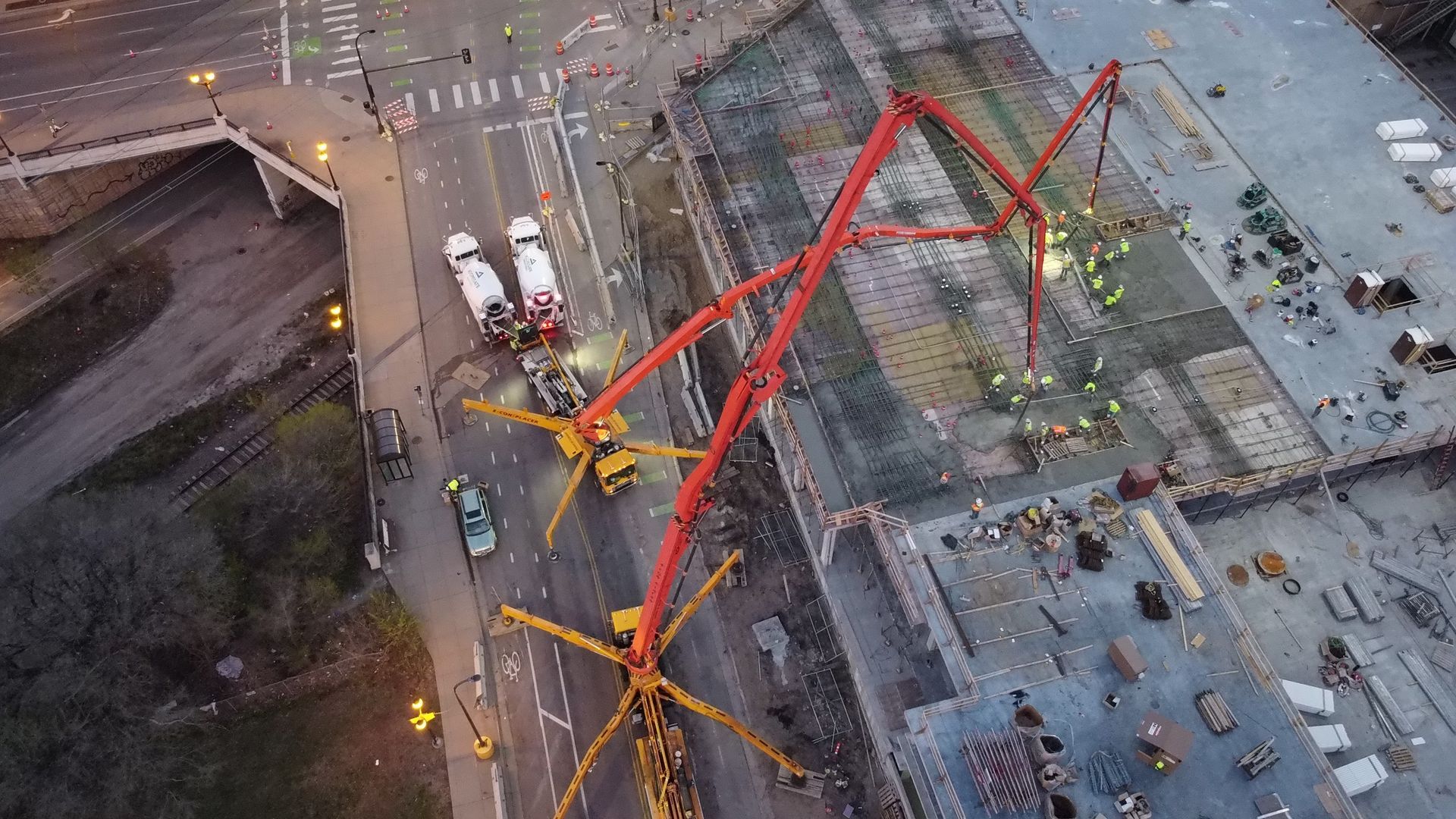An aerial view of a construction site with a concrete pump.