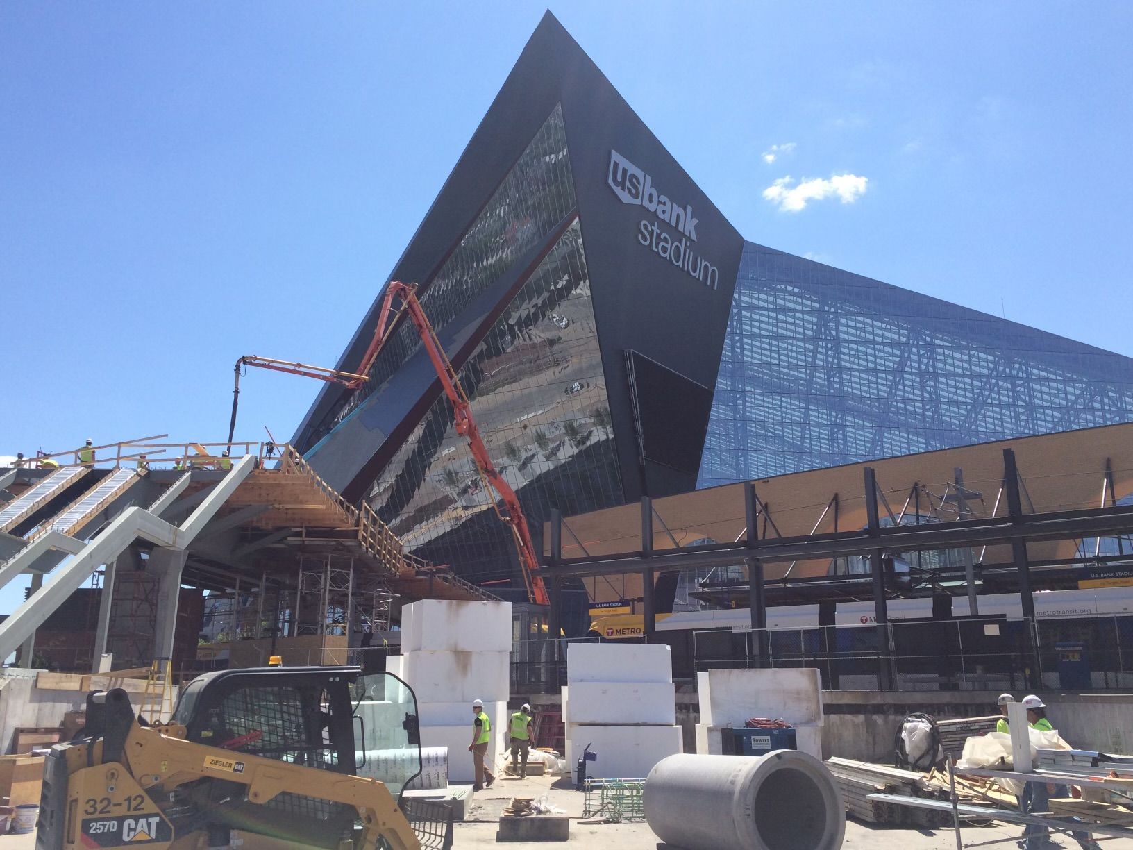 A large building is being built in the middle of a construction site.